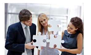adults holding jigsaw pieces