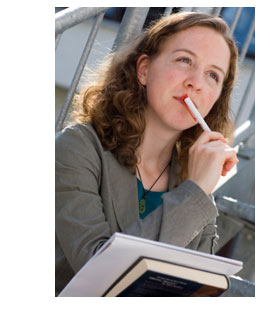 woman with book and papers thinking