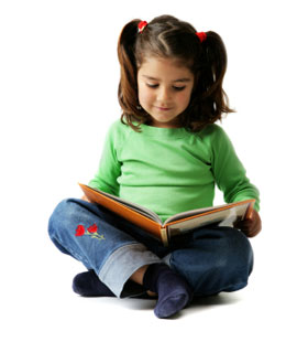 young girl sitting cross-legged reading